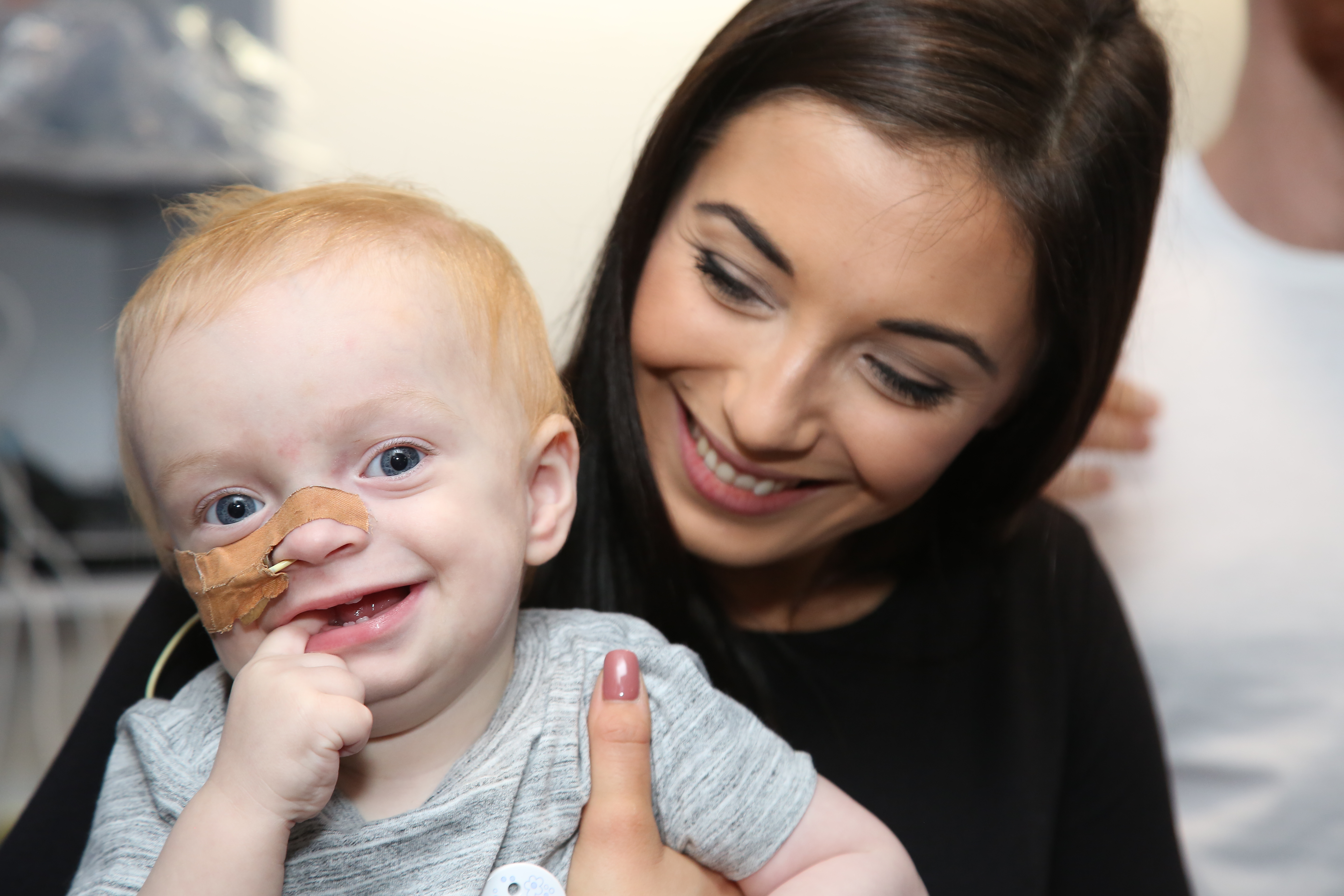 Mother holding young child in hospital